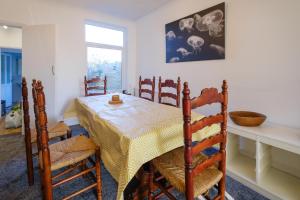 a dining room with a table and chairs and a window at 39 Carr Avenue - Aldeburgh Coastal Cottages in Leiston