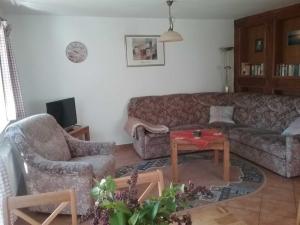 a living room with a couch and a table at Landhaus im Grünen - Carpe Diem in Grammendorf