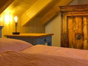 a bedroom with a bed and a wooden counter at Chata GOLDENBACH in Malá Morava