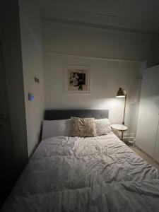 a bedroom with a large bed with a white comforter at Gorgeous 1 bed flat near Richmond Bridge. in Richmond