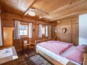 a bedroom with a bed in a wooden cabin at Going Artenreich in Going