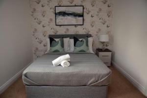 a bedroom with a large bed with green pillows at Spacious 3 Bed House in Bristol in Bristol
