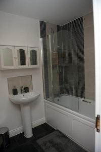 a bathroom with a sink and a shower at Spacious 3 Bed House in Bristol in Bristol