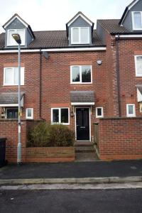 a brick house with a black door and a street light at Spacious 3 Bed House in Bristol in Bristol