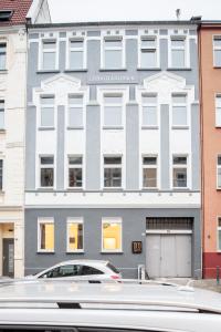 a white car parked in front of a building at TM Studio in Dortmund