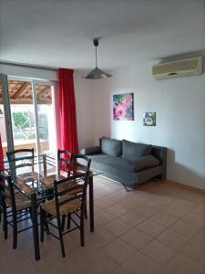 a living room with a table and a couch at Domaine des Garrigues in Grospierres