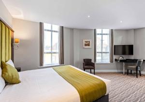 a hotel room with a bed and a desk at St Nicholas Hotel in Colchester