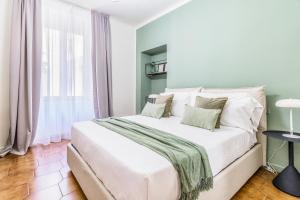 a white bed in a room with a window at BePlace Apartments in Porta Garibaldi in Milan