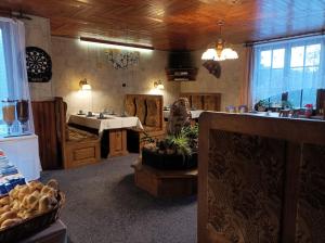 a restaurant with a table and chairs in a room at Pension DORO in Černý Dŭl