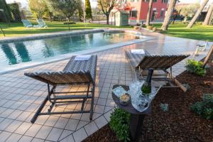two chairs and a table next to a swimming pool at DOLF - Villa Elisa - Intera Villa in Tolentino