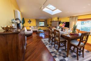 a dining room and living room with a table and chairs at DOLF - Villa Elisa - Intera Villa in Tolentino