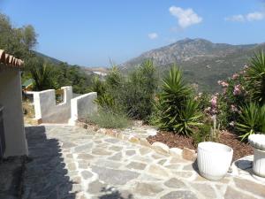 a stone walkway with a view of a mountain at IN'D'NOI in Ajaccio