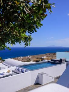 a villa with a swimming pool and a view of the ocean at LF Suites & Villas in Imerovigli