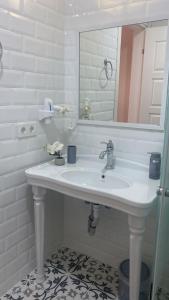 a bathroom with a white sink and a mirror at Hera Hotels Alaçatı in Cesme