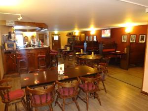 a restaurant with tables and chairs and a bar at St. Cyrus Village Inn in Saint Cyrus