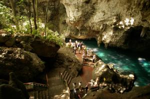 a group of people standing in a river in a cave at Spacious Quiet Double Room Near Megacentro - 10 min drive in La Viva