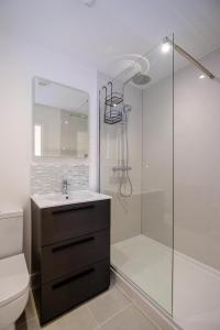 a bathroom with a shower and a sink and a toilet at Three Tuns - Garden Suite 1 in Wickham Market