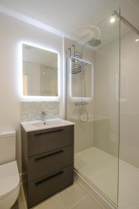 a bathroom with a sink and a shower at Three Tuns - Garden Suite 1 in Wickham Market