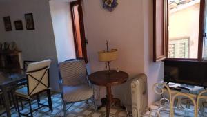 salon ze stołem, krzesłami i telewizorem w obiekcie Terratetto Indipendente Capraia w mieście Capraia