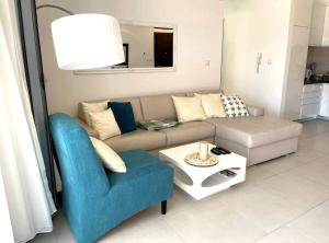 a living room with a couch and a table at Lavender Bay Apartment in Donji Morinj