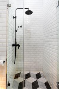 a shower in a bathroom with a glass shower stall at S Loft Manado in Manado