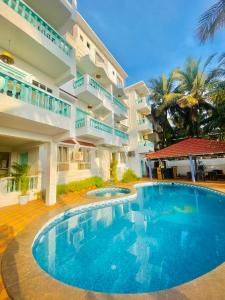 a large swimming pool in front of a building at THE TURQUOIISE HOUSE in Morjim