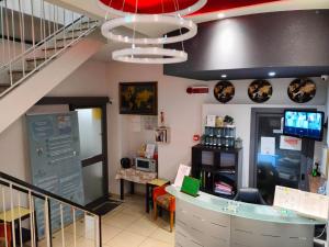 a restaurant with a staircase and a counter at Hotel Convertini in Milan
