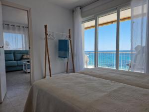sypialnia z łóżkiem i widokiem na ocean w obiekcie EDIFICIO RIO w mieście Calpe