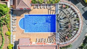 an overhead view of a swimming pool with a slide at Villa Sea Renity - Palheiro Village by ALMA Holiday Rentals in Funchal