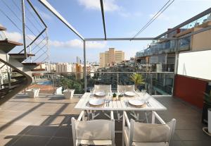 a balcony with a table and chairs on a building at Edificio Borumbot in Calpe