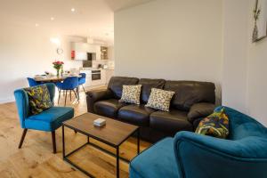 a living room with a couch and chairs and a table at Three Tuns - Garden Suite 2 in Wickham Market