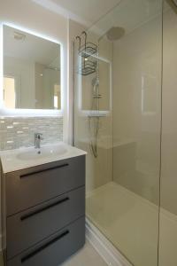 a bathroom with a sink and a shower at Three Tuns - Garden Suite 2 in Wickham Market