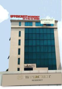 a building with a sign on top of it at UPPERCREST RESIDENCY PALA in Pala