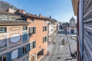 a city street with buildings and a clock tower at Center Salo in Salò