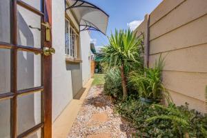 an entrance to a house with a door and plants at Ovendales Self Catering Cottage in Benoni