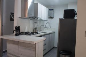 a kitchen with a sink and a counter top at Espectacular apartaestudio en sabaneta! in Sabaneta