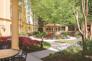 a garden with a table and a gazebo at La Quinta Inn & Suites by Wyndham University Area Chapel Hill in Durham