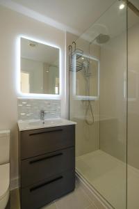 a bathroom with a sink and a shower with a mirror at Three Tuns - Garden Suite 3 in Wickham Market