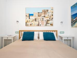 a bedroom with a bed with two tables and a painting on the wall at Artist House in Positano in Positano