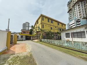 an empty street in a city with tall buildings at OYO 90706 Empire Inn 2 in Kota Bharu