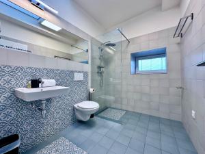 a bathroom with a toilet and a sink and a shower at DOBRÉ MÍSTO in Krnov