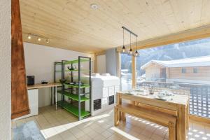 a kitchen with a table and a green shelf at Residence de Lognan- Les Jorasses 27 - Happy Rentals in Chamonix