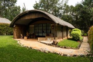 a small hut with a thatched roof at Poa Place Resort in Eldoret