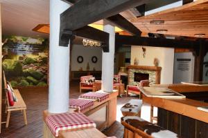a dining room with tables and chairs and a fireplace at Appartement Wolf Nummer 69 in Baiersbronn