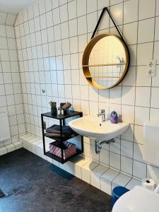 a bathroom with a sink and a mirror at Shadow Sleep 2.0 in Schonungen