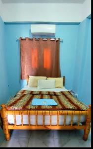 a bed with a wooden headboard in a room at Dahab in Dahab