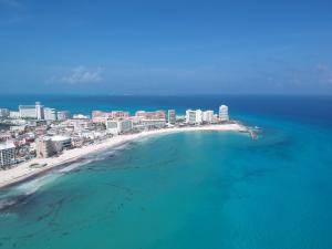 an aerial view of a beach with buildings and the ocean at Studio 101 in the heart of the Hotel Zone in Cancún