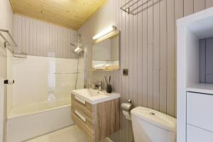a bathroom with a sink and a toilet and a mirror at Residence de Lognan- Les Jorasses 27 - Happy Rentals in Chamonix