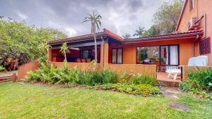 a home with a patio and a house at San Lameer 2401 by Top Destinations Rentals in Southbroom