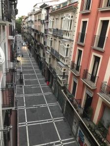 an empty street in a city with buildings at Apartamento Ayla Camino de Santiago in Pamplona
